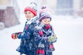 Happy children having fun with snow in winter Royalty Free Stock Photo