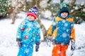 Happy children having fun with snow in winter Royalty Free Stock Photo