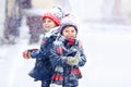 Happy children having fun with snow in winter Royalty Free Stock Photo