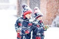 Happy children having fun with snow in winter Royalty Free Stock Photo