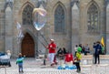 Happy children having fun at a soap bubble show performed by a local street artist Royalty Free Stock Photo