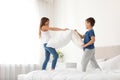 Happy children having pillow fight Royalty Free Stock Photo