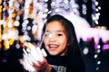 Happy children Holding a light on a New Year`s Eve.Street Night Scene with Christmas Lights . Christmas evening Concept Royalty Free Stock Photo