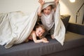 Happy children at home play on sofa bed. Royalty Free Stock Photo