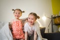 Happy children at home play on sofa bed. Royalty Free Stock Photo