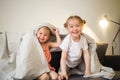 Happy children at home play on sofa bed. Royalty Free Stock Photo