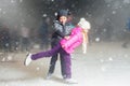 Happy children ice skating at ice rink, winter night Royalty Free Stock Photo