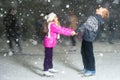 Happy children ice skating at ice rink, winter night Royalty Free Stock Photo