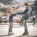 Happy children ice skating at rink outdoor Royalty Free Stock Photo