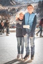 Happy children ice skating at rink outdoor Royalty Free Stock Photo