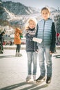 Happy children ice skating at rink outdoor Royalty Free Stock Photo