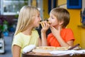 Happy children indoors eating pizza smiling Royalty Free Stock Photo