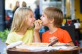 Happy children indoors eating pizza smiling