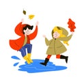 Happy children jump in the puddle under the rain. Autumn Royalty Free Stock Photo