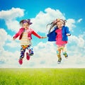 Happy children jumping on the spring field Royalty Free Stock Photo