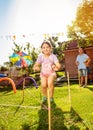 Happy children jumps over strings on playground