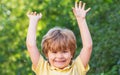 Happy children kid boy with hands up. Child outdoors in nature. Happy child. Funny baby boy isolated on a background of Royalty Free Stock Photo