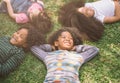 Happy children kids laying on grass in park. Royalty Free Stock Photo
