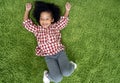 Happy children kids smiling and laying on green carpet floor in living room at home. Royalty Free Stock Photo