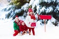 Children with letter to Santa at Christmas mail box in snow Royalty Free Stock Photo