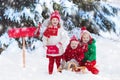 Children with letter to Santa at Christmas mail box in snow Royalty Free Stock Photo