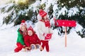 Children with letter to Santa at Christmas mail box in snow Royalty Free Stock Photo