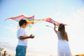 Happy children launch a kite in the field at sunset. Little boy and girl on summer vacation. Royalty Free Stock Photo