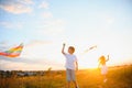 Happy children launch a kite in the field at sunset. Little boy and girl on summer vacation. Royalty Free Stock Photo