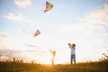 Happy children launch a kite in the field at sunset. Little boy and girl on summer vacation. Royalty Free Stock Photo