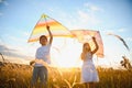 Happy children launch a kite in the field at sunset. Little boy and girl on summer vacation. Royalty Free Stock Photo