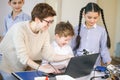 Happy children learn programming using laptops on extracurricular classes Royalty Free Stock Photo