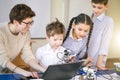 Happy children learn programming using laptops on extracurricular classes