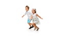 Happy children, little caucasian boy and girl jumping and running isolated on white background Royalty Free Stock Photo