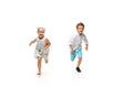 Happy children, little caucasian boy and girl jumping and running isolated on white background Royalty Free Stock Photo