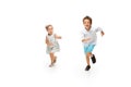 Happy children, little caucasian boy and girl jumping and running isolated on white background Royalty Free Stock Photo