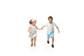 Happy children, little caucasian boy and girl jumping and running isolated on white background Royalty Free Stock Photo