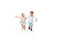 Happy children, little caucasian boy and girl jumping and running isolated on white background Royalty Free Stock Photo