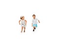 Happy children, little caucasian boy and girl jumping and running isolated on white background Royalty Free Stock Photo