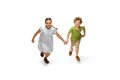 Happy little caucasian girl and boy jumping and running isolated on white background Royalty Free Stock Photo