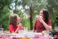 Happy children making funny faces eating