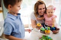 Happy children with mother eating cupcakes Royalty Free Stock Photo