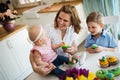 Happy children with mother eating cupcakes Royalty Free Stock Photo