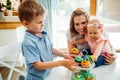 Happy children with mother eating cupcakes Royalty Free Stock Photo