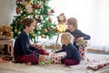 Happy children, opening presents on christmas day Royalty Free Stock Photo