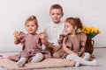 Happy children play in a room with flowers. Brother and sisters together