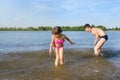 Happy children playing on the beach during the daytime.  Water games Royalty Free Stock Photo