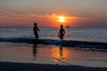 Happy Children Playing On The Beach During Sunset Time Summer Vacation And Healthy Lifestyle Concept Royalty Free Stock Photo