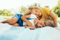 Happy children playing on the blanket outdoors. Cheerful little boy and cute little girl smiling and relaxing in the park. Kids Royalty Free Stock Photo