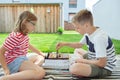 Happy children playing chess on backyard at sunny day while summer holidays Royalty Free Stock Photo