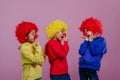 Happy children playing on clowns, studio shoot.